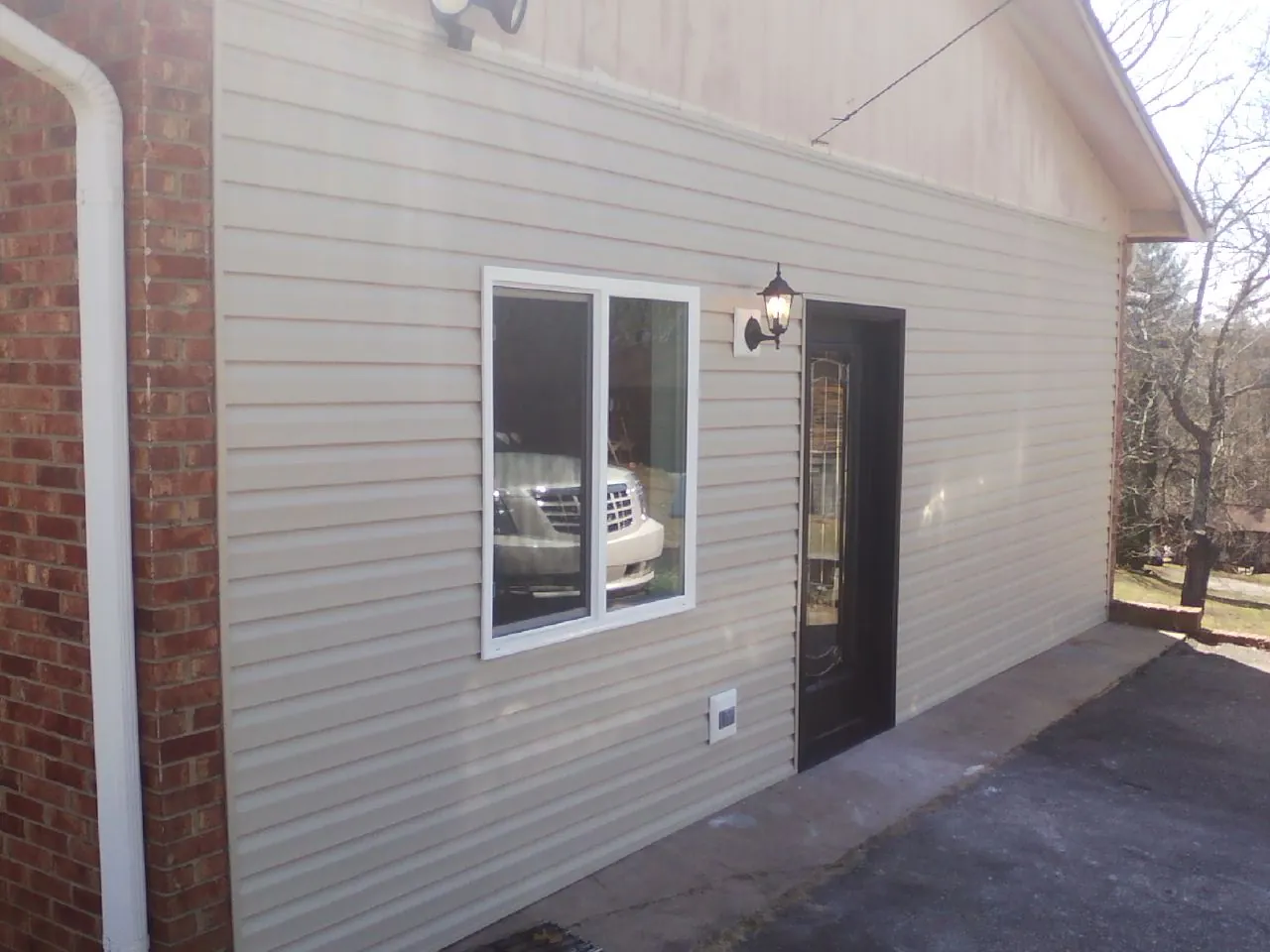 New vinyl siding and entry door on a room addition in West Salisbury