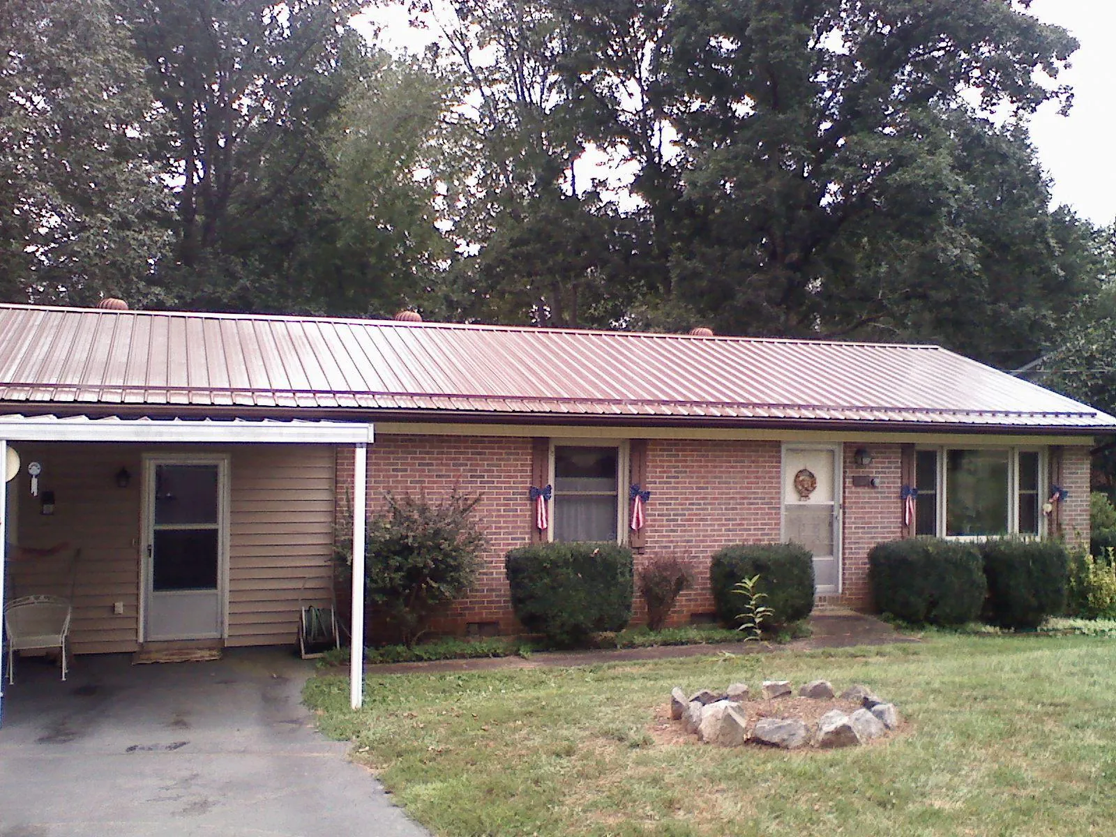 Bronze metal roof and carport on a brick ranch home — Roof Repair work by our crew in West Salisbury
